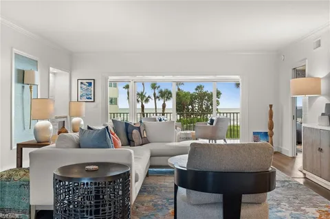 a living room with furniture and a floor to ceiling window