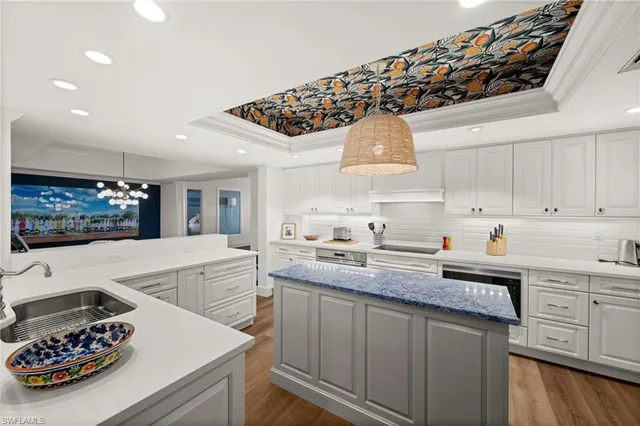 a kitchen with a sink a stove and cabinets
