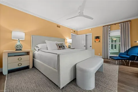 a bed room with a bed and a chair