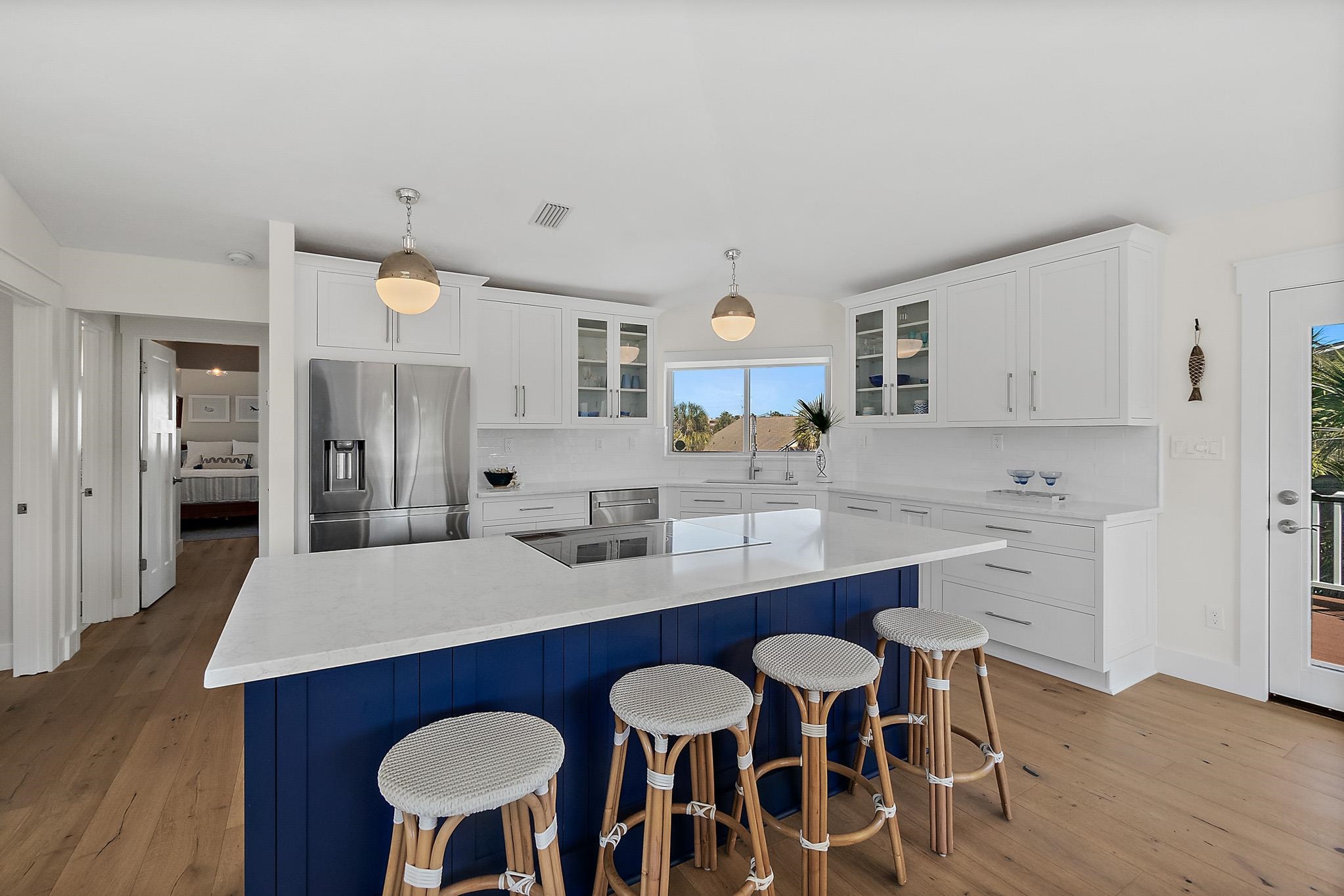 7 Sabor De Sal Road St. Augustine, FL 32080 - Photo 12 of 59 a large kitchen with granite countertop a dining table chairs stainless steel appliances and cabinets