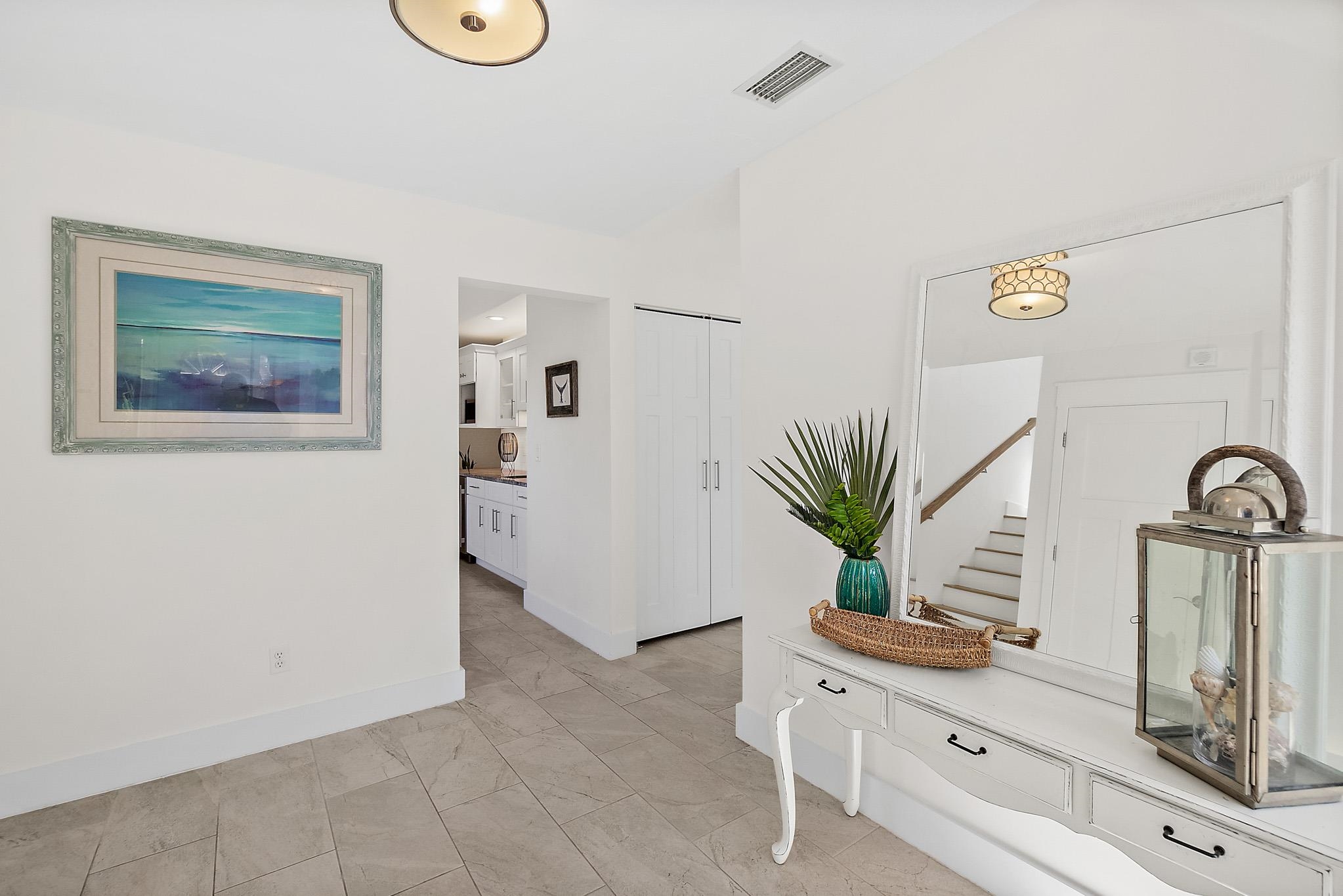 7 Sabor De Sal Road St. Augustine, FL 32080 - Photo 32 of 59 a bathroom with a sink a mirror and a potted plant