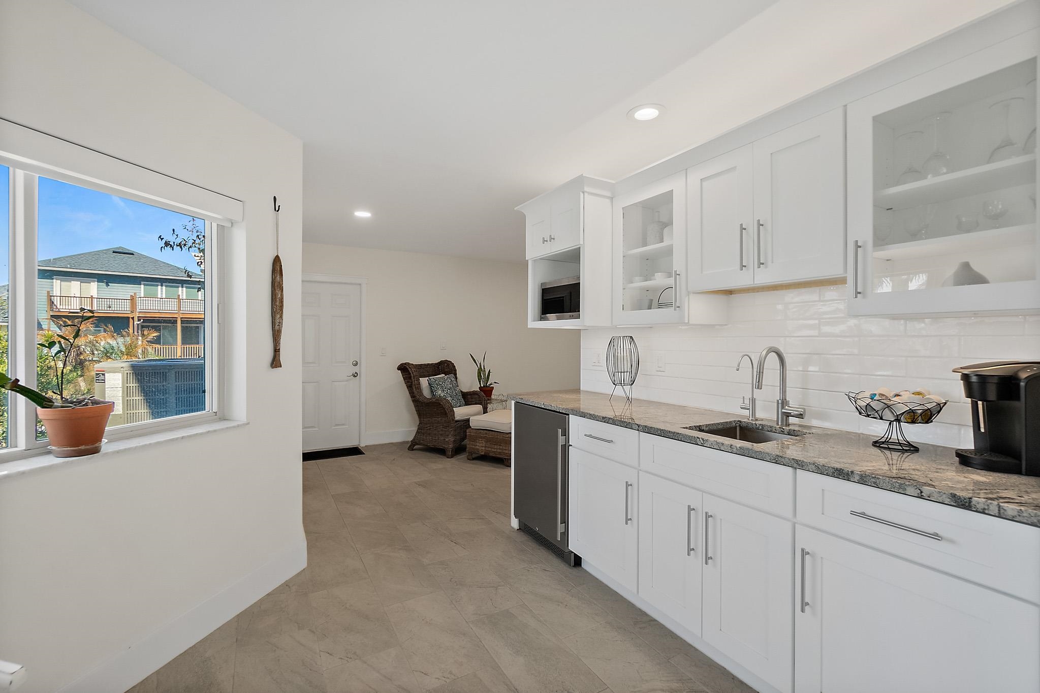 7 Sabor De Sal Road St. Augustine, FL 32080 - Photo 40 of 59 Kitchenette featuring light stone counters, white cabinets, tasteful backsplash, recessed lighting, and glass fronted cabinets