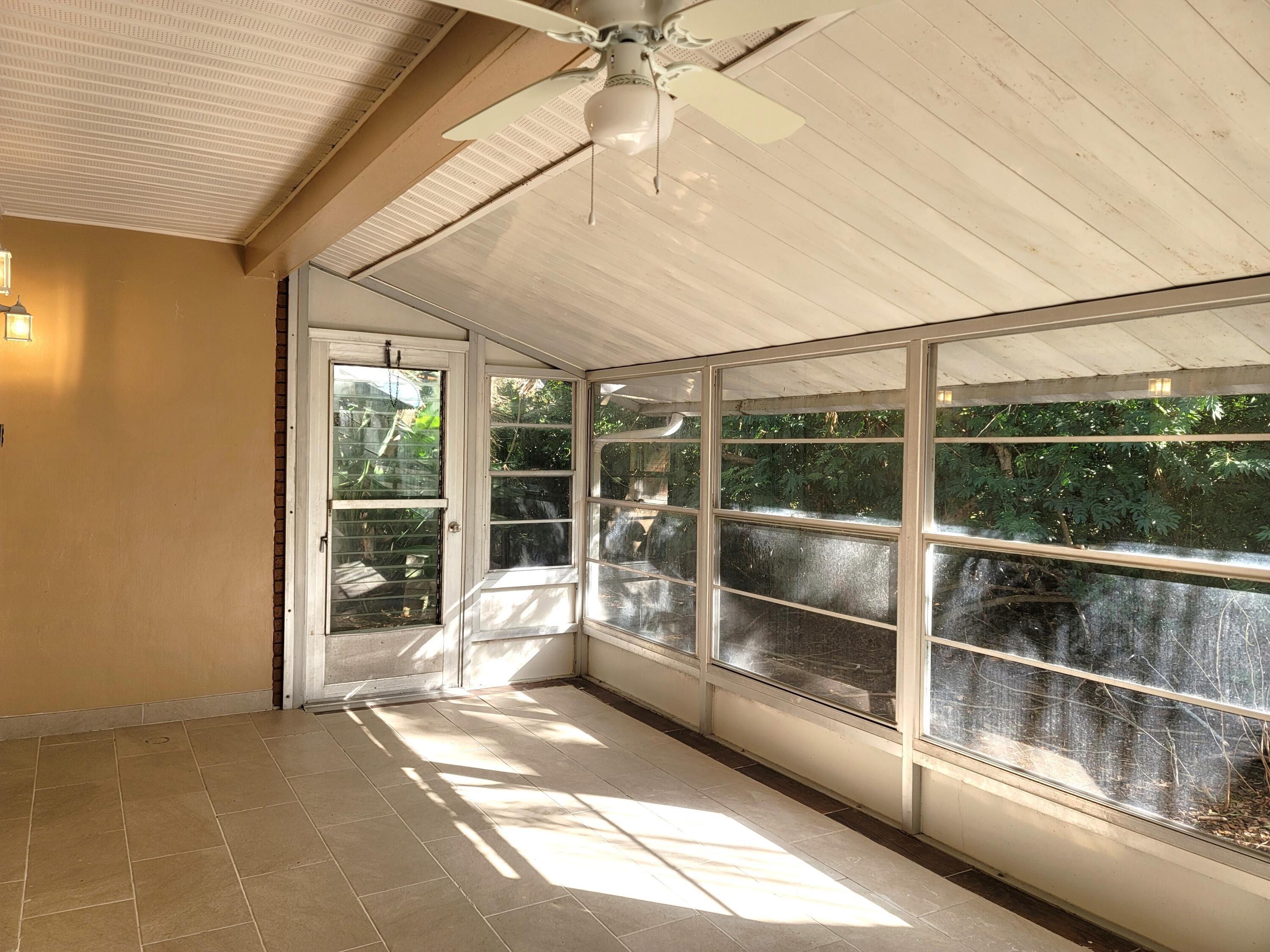 4362 West Midway Road Fort Pierce, FL 34981 - Photo 20 of 29 FRONT PORCH SCREENED BY TREES AND PLANTS