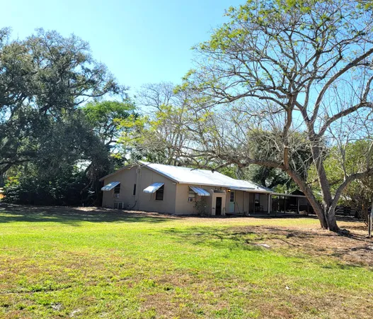 a front view of house with yard and trees