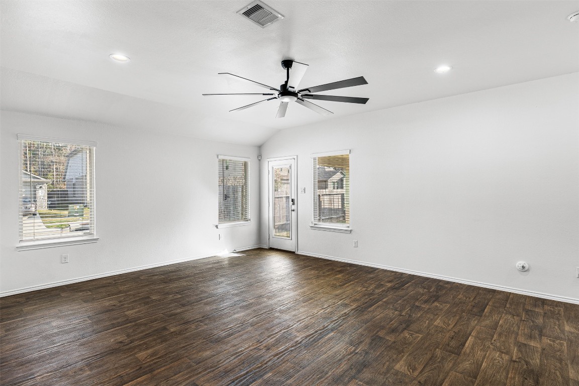 16016 Birch Bay Lane Conroe, TX 77384 - Photo 17 of 37 a view of an empty room with a window and wooden floor