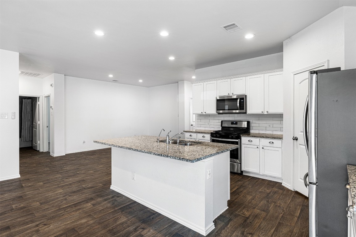 16016 Birch Bay Lane Conroe, TX 77384 - Photo 18 of 37 a kitchen with a refrigerator stove and microwave