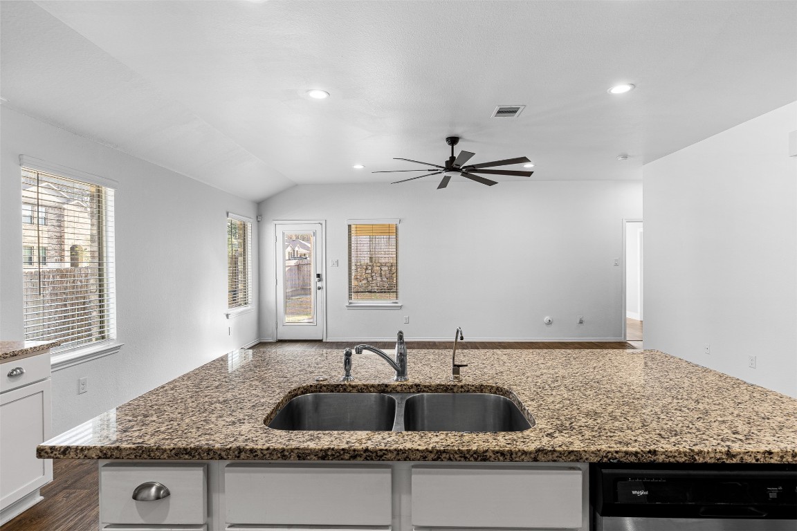 16016 Birch Bay Lane Conroe, TX 77384 - Photo 19 of 37 a kitchen with granite countertop a sink and a window