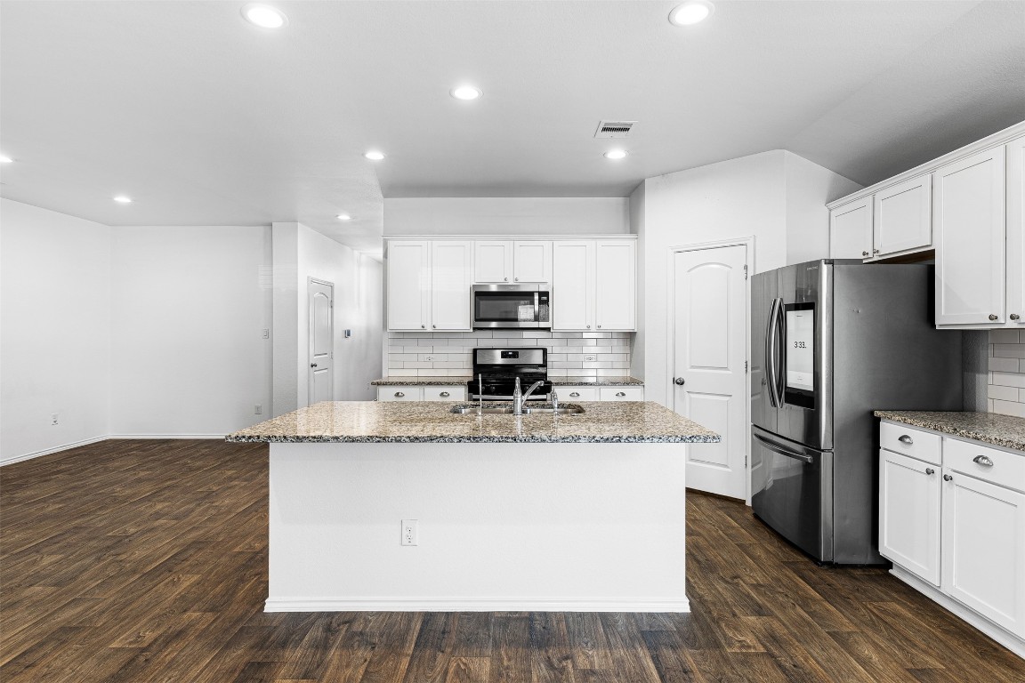 16016 Birch Bay Lane Conroe, TX 77384 - Photo 20 of 37 a kitchen with kitchen island a counter top space appliances and cabinets