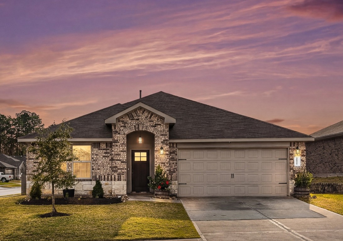 16016 Birch Bay Lane Conroe, TX 77384 - Photo 2 of 37 a front view of a house with a yard