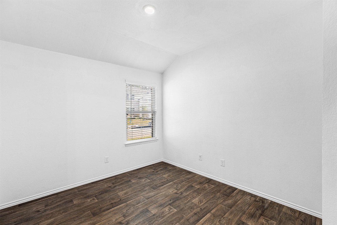 16016 Birch Bay Lane Conroe, TX 77384 - Photo 24 of 37 an empty room with wooden floor and windows