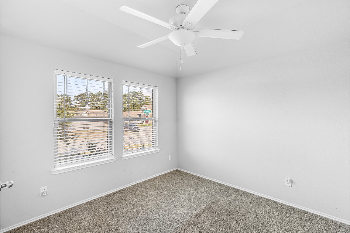 16016 Birch Bay Lane Conroe, TX 77384 - Photo 25 of 37 an empty room with a window and a fan