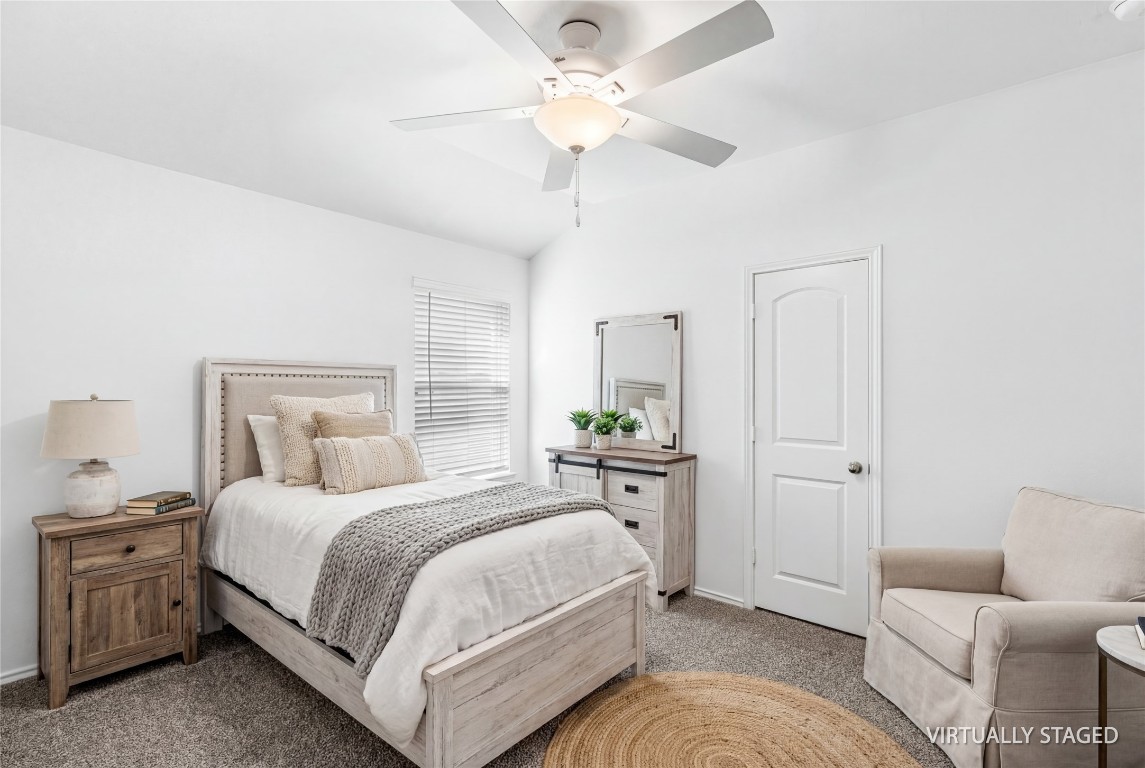 16016 Birch Bay Lane Conroe, TX 77384 - Photo 27 of 37 a bedroom with a bed and a chandelier