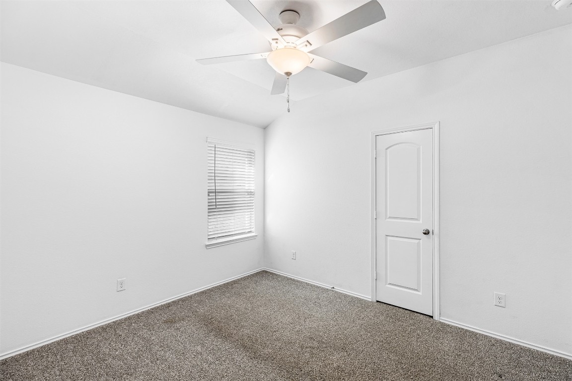 16016 Birch Bay Lane Conroe, TX 77384 - Photo 28 of 37 an empty room with a ceiling fan and a window