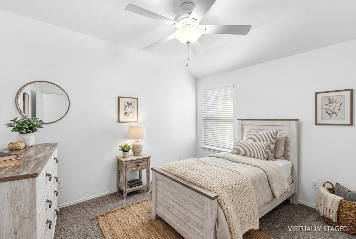 16016 Birch Bay Lane Conroe, TX 77384 - Photo 30 of 37 a bedroom with a bed and a chandelier