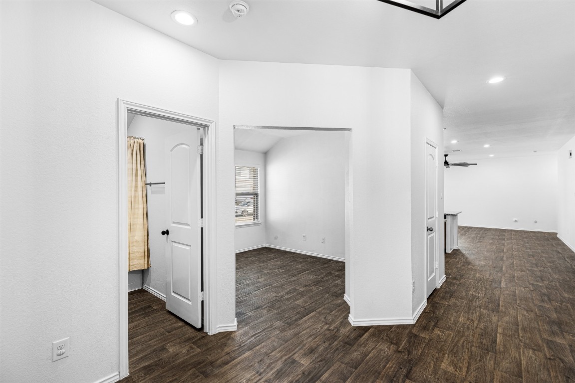16016 Birch Bay Lane Conroe, TX 77384 - Photo 5 of 37 a view of a hallway with wooden floor and a bathroom