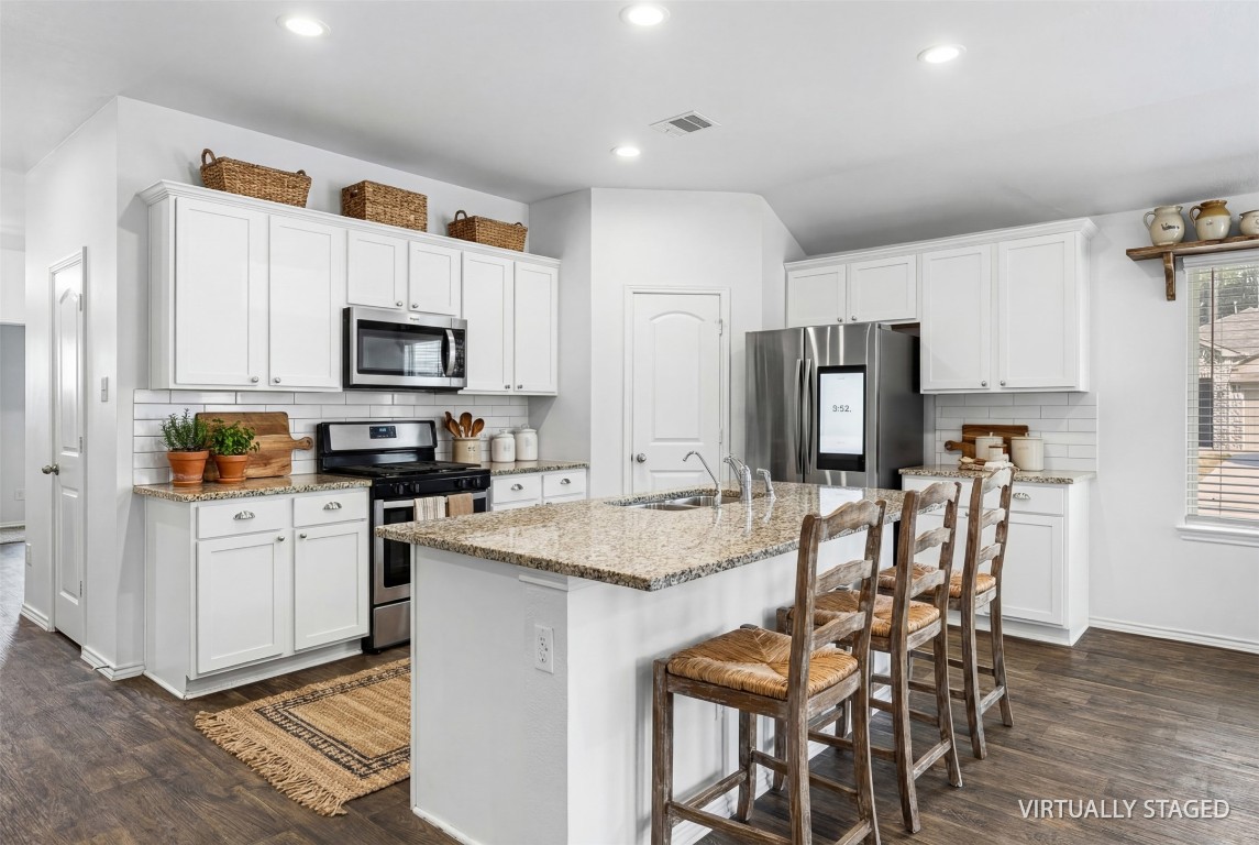 16016 Birch Bay Lane Conroe, TX 77384 - Photo 6 of 37 a kitchen with refrigerator cabinets and wooden floor