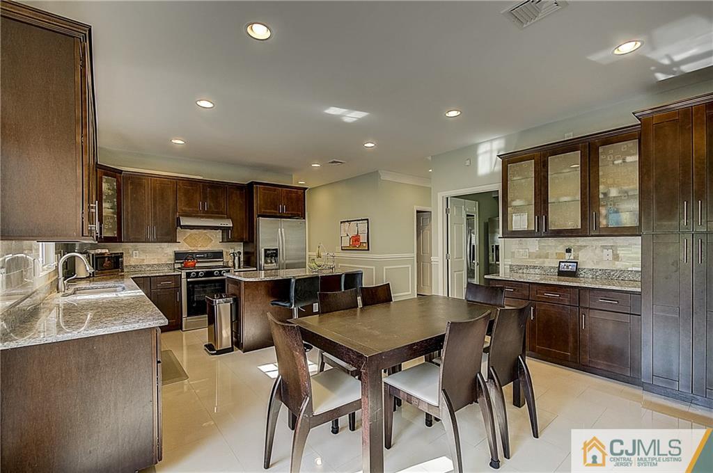 35 Williams Road Edison, NJ 08820 - Photo 12 of 47 a kitchen with a table chairs microwave and cabinets