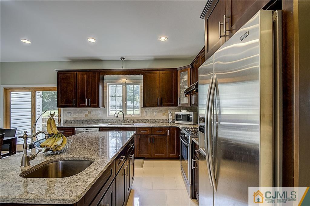 35 Williams Road Edison, NJ 08820 - Photo 15 of 47 a kitchen with kitchen island granite countertop a sink stainless steel appliances and cabinets