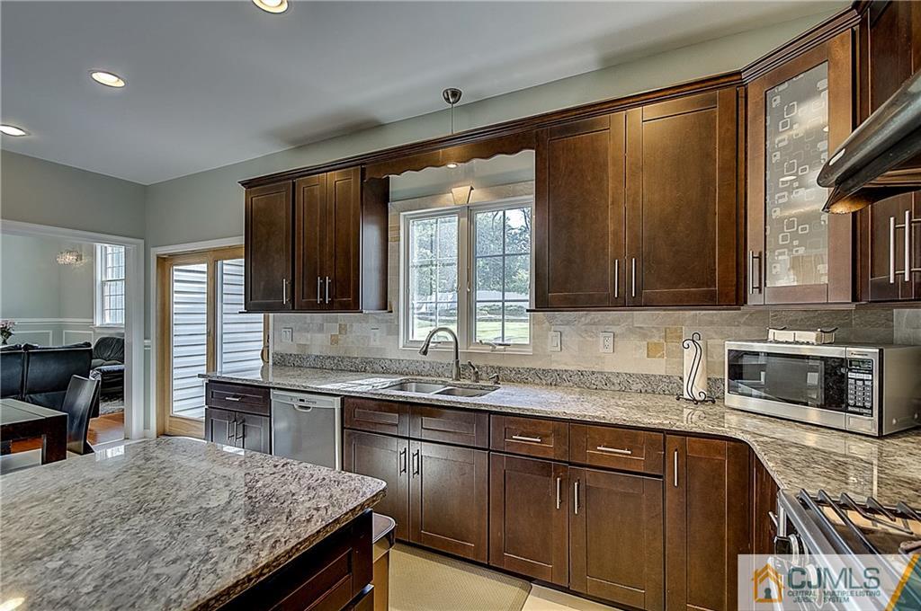 35 Williams Road Edison, NJ 08820 - Photo 16 of 47 a kitchen with granite countertop stainless steel appliances a sink stove and cabinets