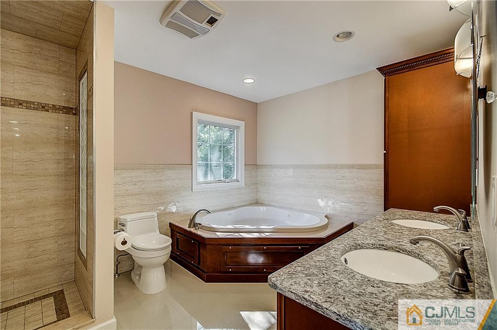 35 Williams Road Edison, NJ 08820 - Photo 33 of 47 a bathroom with a granite countertop bathtub sink vanity mirror and toilet