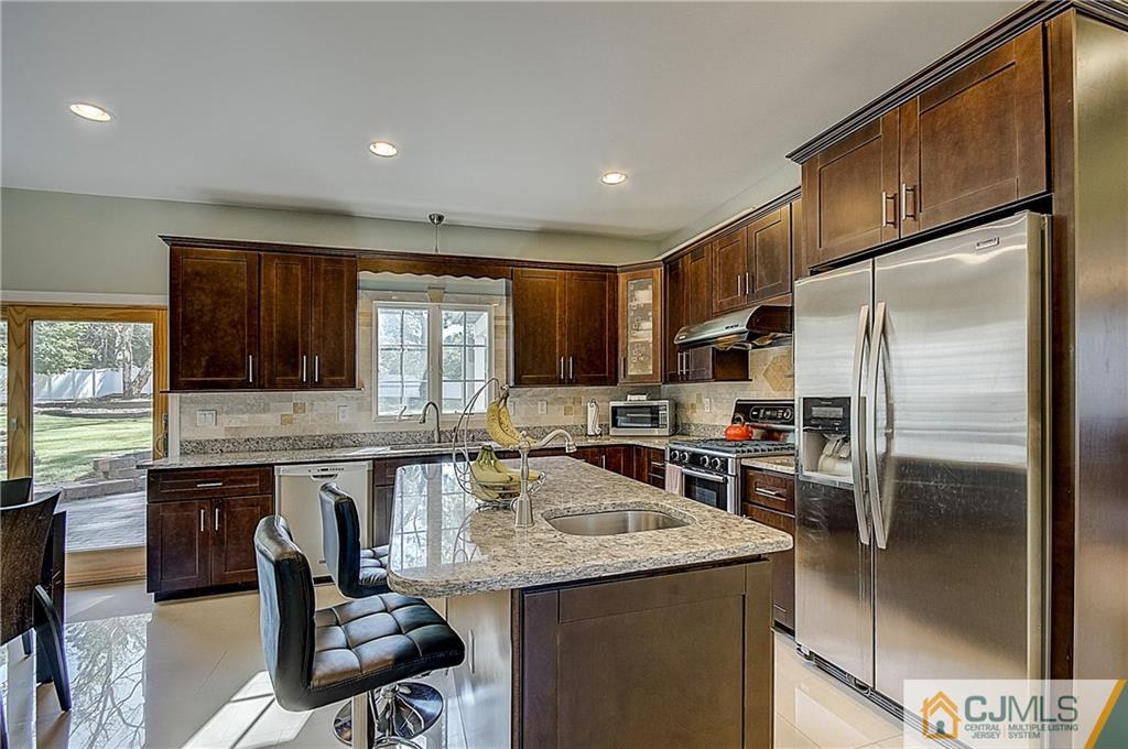 35 Williams Road Edison, NJ 08820 - Photo 9 of 47 a kitchen with granite countertop a sink stainless steel appliances and cabinets
