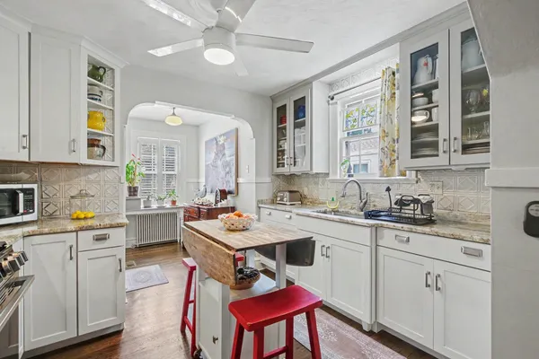 a kitchen with a stove a sink and cabinets