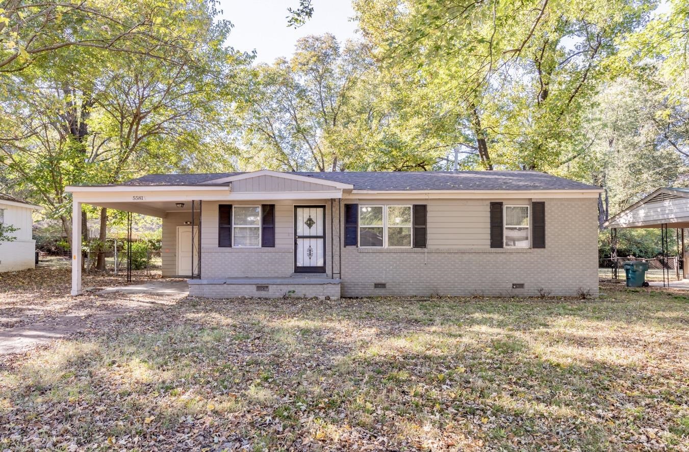 5581 Lochinvar Road Memphis, TN 38116 - Photo 1 of 19 a view of a house with a large tree and a yard