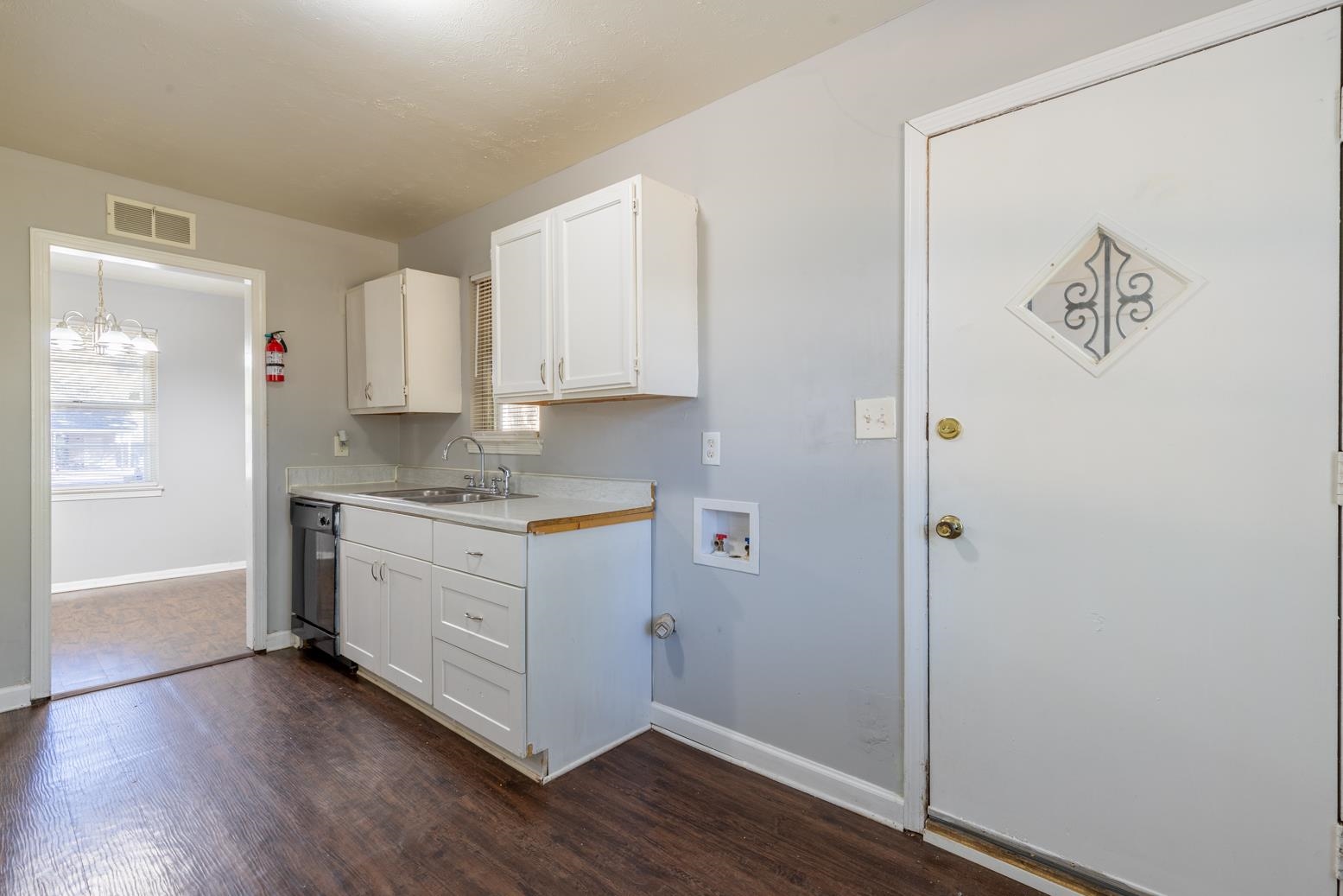 5581 Lochinvar Road Memphis, TN 38116 - Photo 11 of 19 a room with granite countertop white cabinets and wooden floor