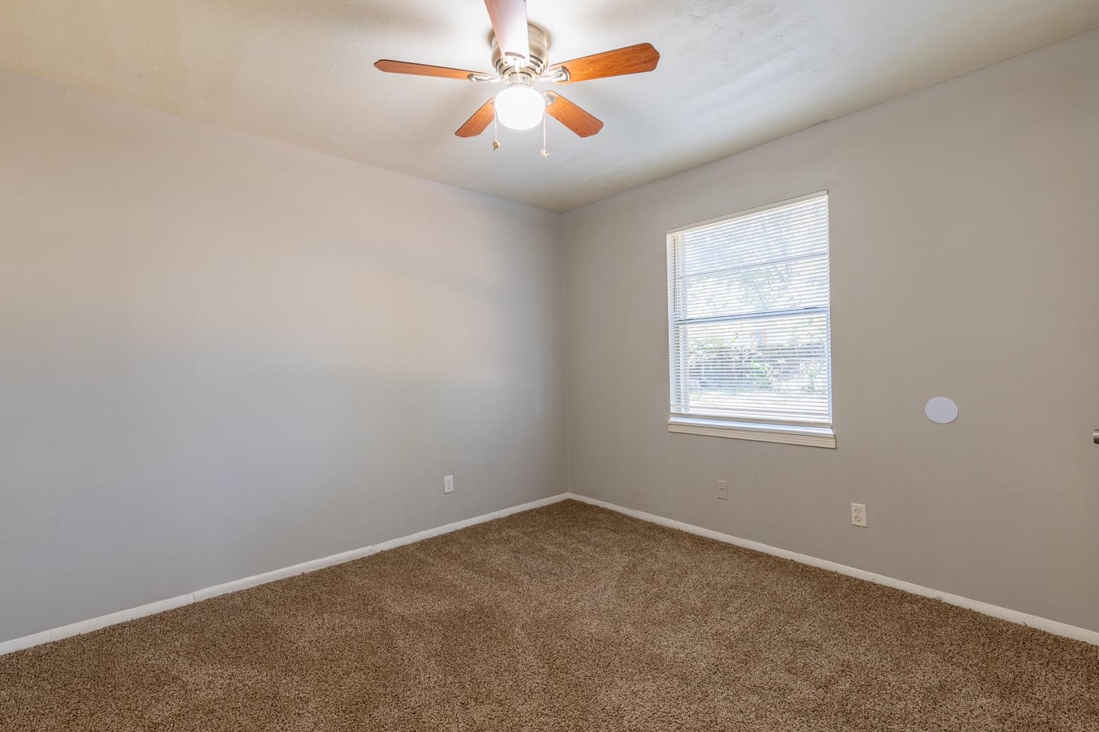5581 Lochinvar Road Memphis, TN 38116 - Photo 13 of 19 an empty room with windows and fan