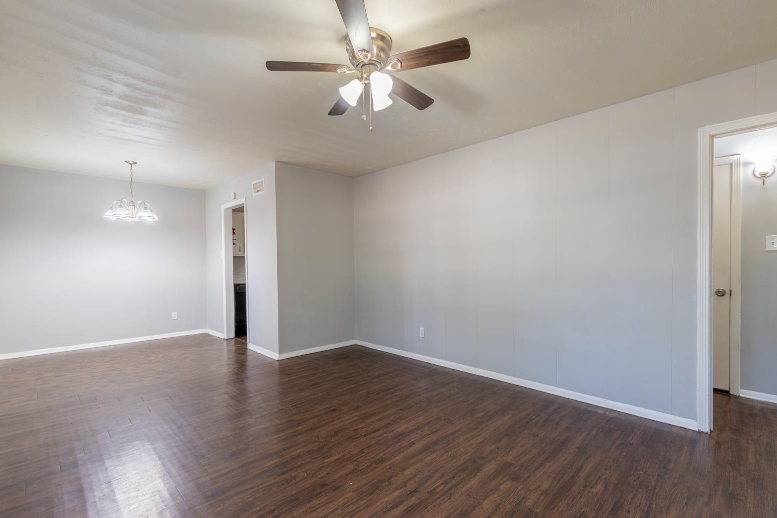 5581 Lochinvar Road Memphis, TN 38116 - Photo 4 of 19 an empty room with wooden floor and a ceiling fan