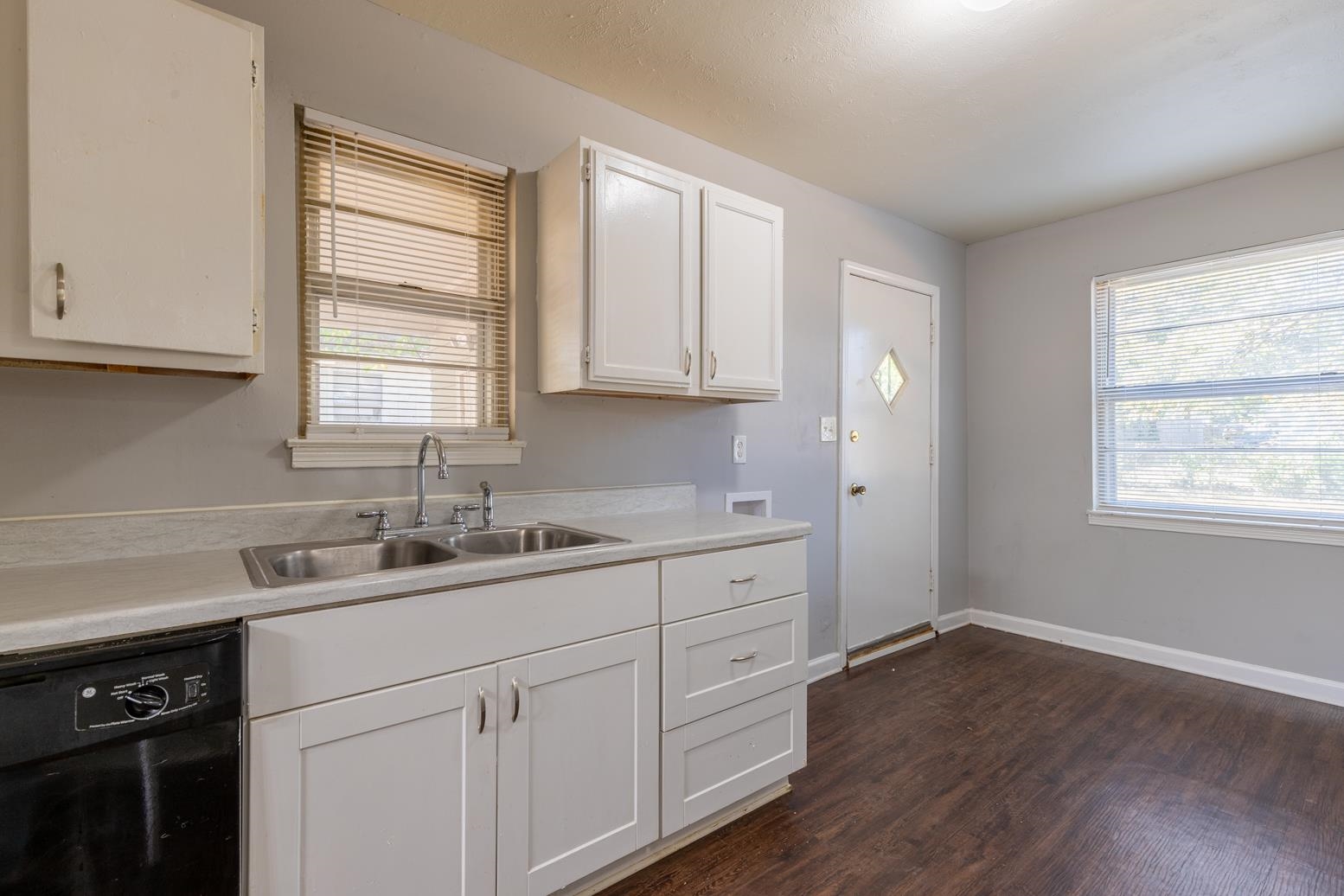 5581 Lochinvar Road Memphis, TN 38116 - Photo 10 of 19 a kitchen with a sink cabinets wooden floor and a window