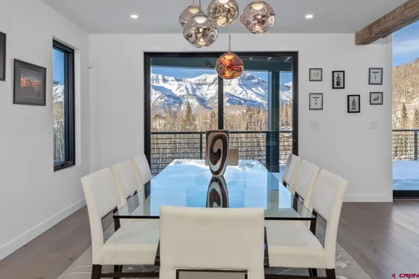 a view of a dining room with furniture wooden floor and a chandelier