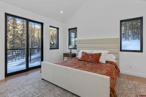 a bedroom with a large bed and a large window