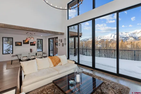 a living room with furniture and a floor to ceiling window