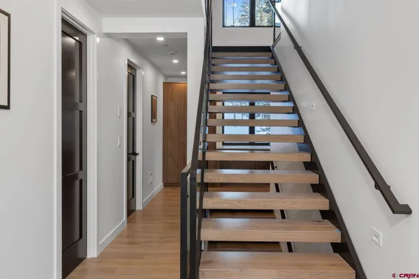 a view of entryway and hall with wooden floor