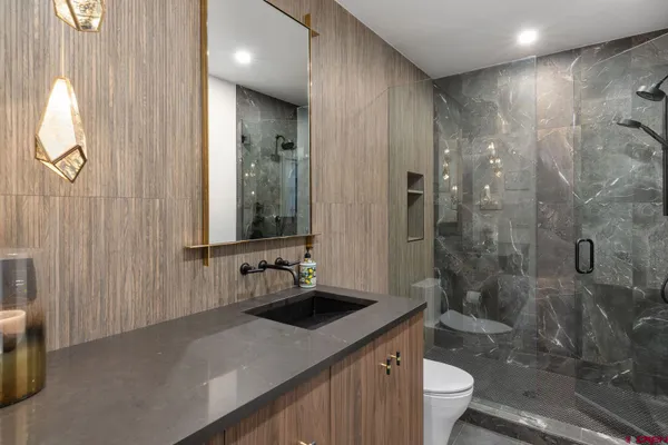 a bathroom with a double vanity sink toilet and shower