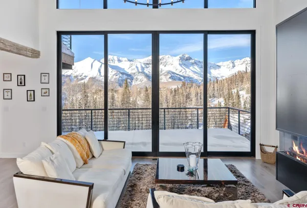 a living room with furniture and a floor to ceiling window