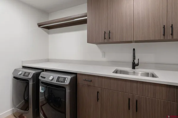 a view of a sink with washer and dryer