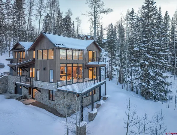 a front view of a house with balcony and wooden stairs