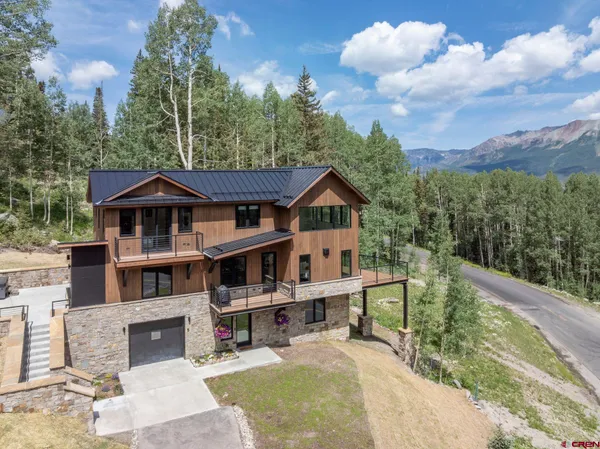 a front view of a house with a yard balcony