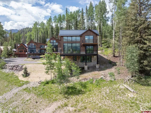 a view of house with yard and sitting area