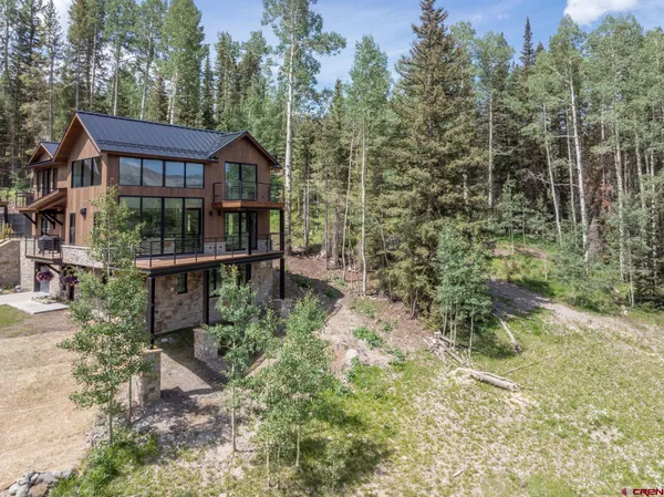 a view of a house with a yard and sitting area