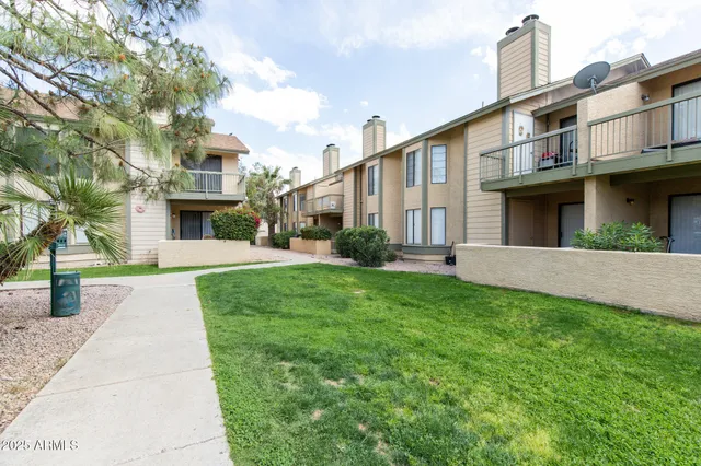 a view of brick house with a yard