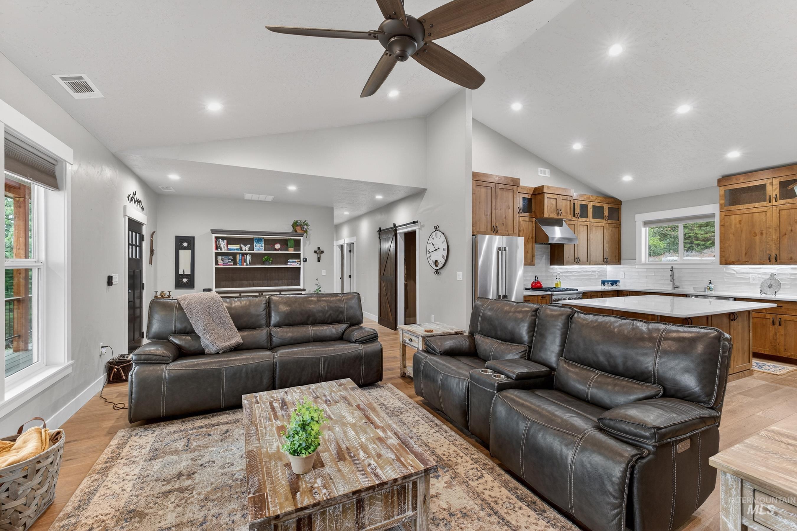 10191 Timberrim Drive Cascade, ID 83611 - Photo 18 of 44 Living room featuring light wood finished floors, ceiling fan, vaulted ceiling, and recessed lighting