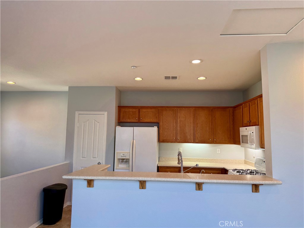 36368 Grazia Way Winchester, CA 92596 - Photo 16 of 27 a kitchen with stainless steel appliances kitchen island sink refrigerator and stove