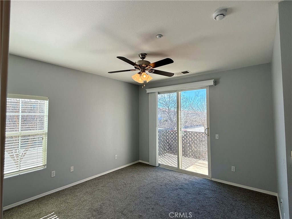 36368 Grazia Way Winchester, CA 92596 - Photo 22 of 27 an empty room with a ceiling fan and window