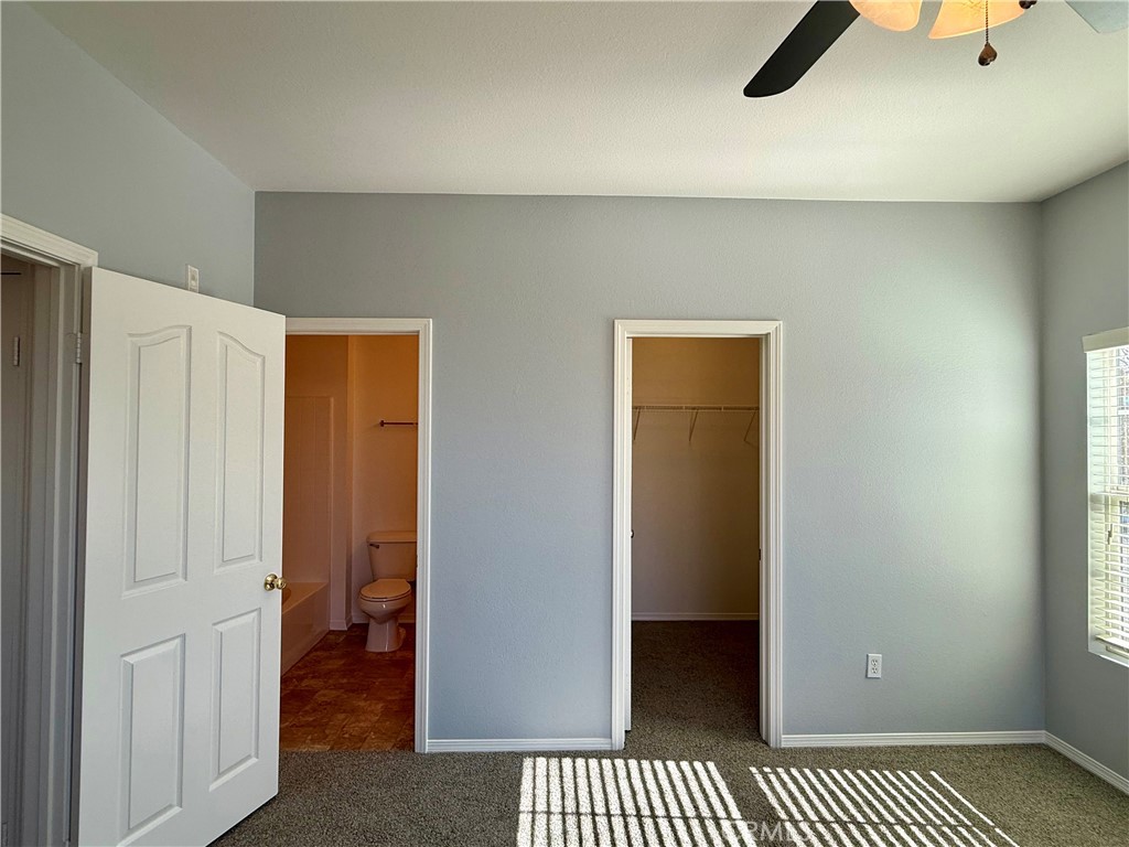 36368 Grazia Way Winchester, CA 92596 - Photo 24 of 27 a view of a livingroom with a walk in closet and bedroom