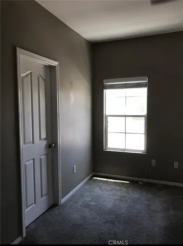 a kitchen with a stove and white cabinets