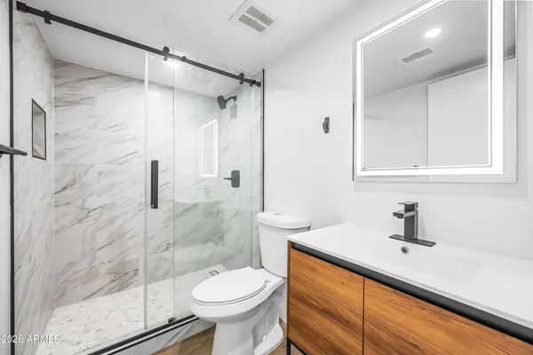 a bathroom with a sink toilet and shower