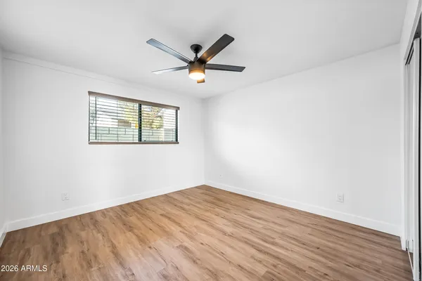a view of a big room with wooden floor and windows in a room